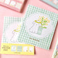 bloc de notas de papelería japonesa con diferentes diseños de perros y gato en primavera, con flores de sakura, mimosa y dulces